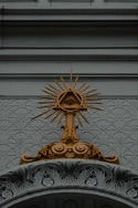 A gold Eye of Providence statue